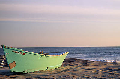NC: Dare County, The Outer Banks, Hatteras Island, Rodanthe, Morning sun hits a beached fishing boat [Ask for #224.413.]