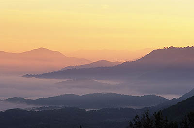 North Carolina: Central Mountains Region, Haywood County, The Blue Ridge Parkway, The Balsam Mountains (South Section), Waynesville Overlook, MP 441, Dawn view over Waynesville, with valley fog and sunrise colors [Ask for #237.512.]