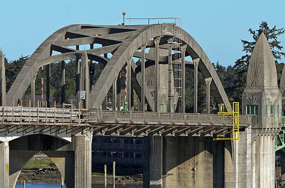 OR: South Coast Region, Lane County, Pacific Coast, Florence Area, Town of Florence, US 101 crosses the Suislaw River inlet on a historic concrete truss bridge designed by Conde McCollough [Ask for #276.462.]