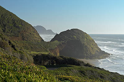 OR: South Coast Region, Lane County, Pacific Coast, Cape Perpetua Area, Roosevelt Beach, US 101 passes behind Rocky Knoll, as viewed from Ocean Beach Picnic Area [Ask for #276.557.]