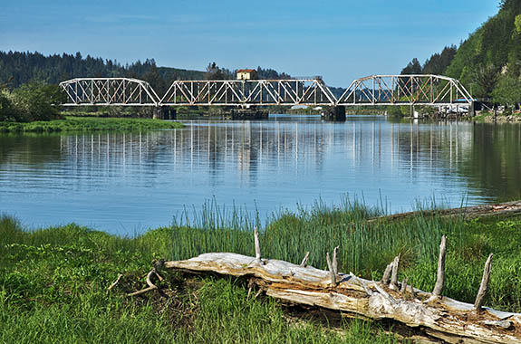 OR: South Coast Region, Lane County, Pacific Coast, Florence Area, Siuslaw River, The Coos Bay Rail Link crosses the river on a three truss steel tressle. [Ask for #276.647.]