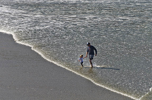 OR: North Coast Region, Lincoln County, Pacific Coast, Yachats Area, Yachats Proper, Yachats State Park, Father and small daughter playing in the surf [Ask for #279.172.]
